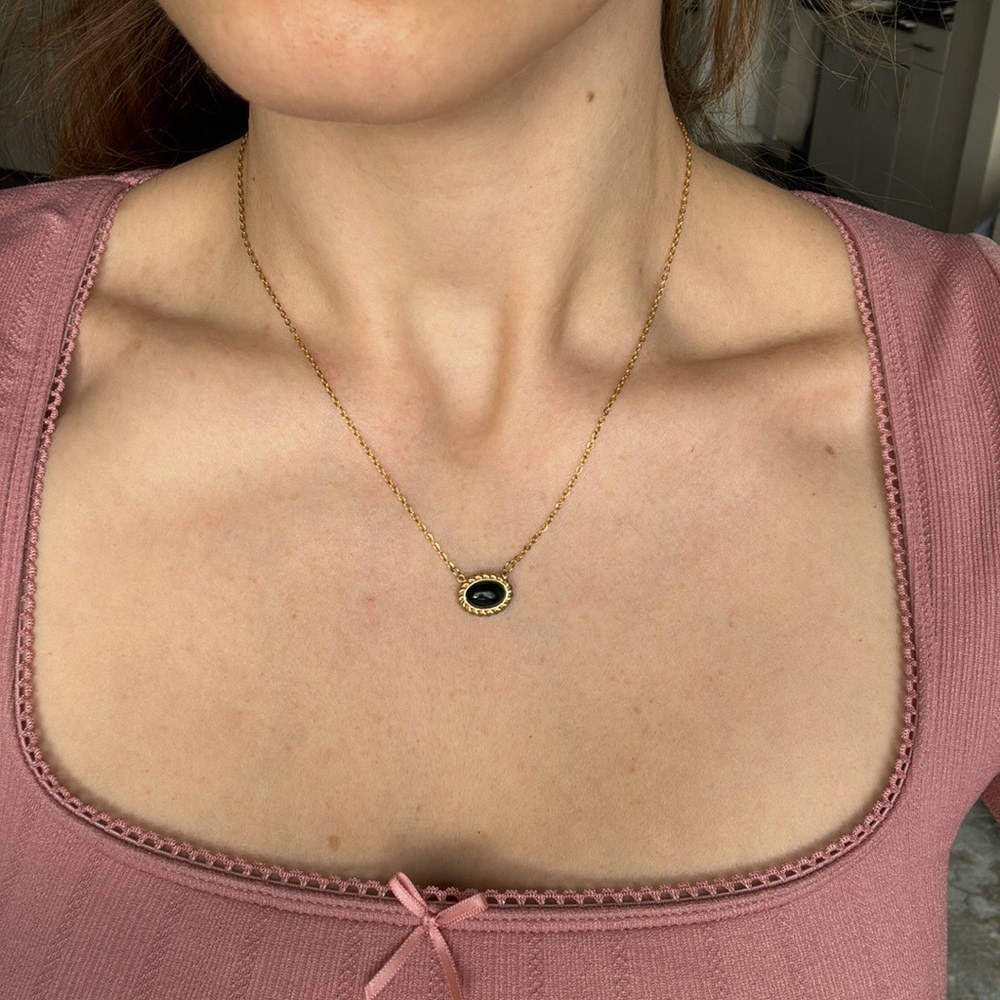 Gold necklace with black stone